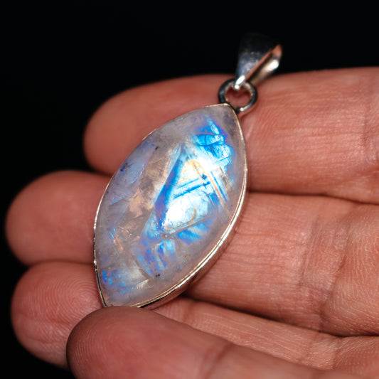 Oval rainbow moonstone pendant with .925 sterling silver bezel and bail