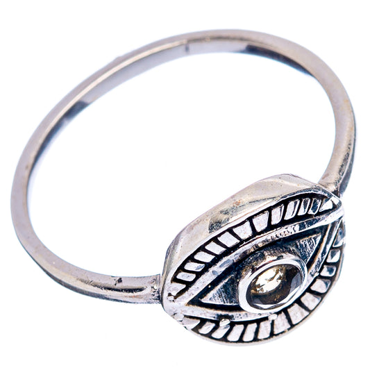 Sterling silver open band with engraved eye design and small round citrine-colored stone