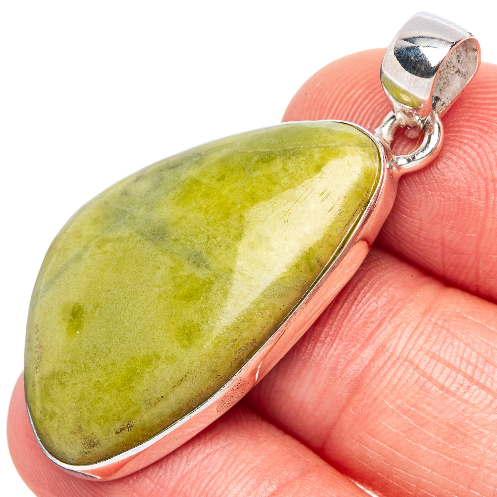 Green serpentine stone pendant in sterling silver bezel with open bail
