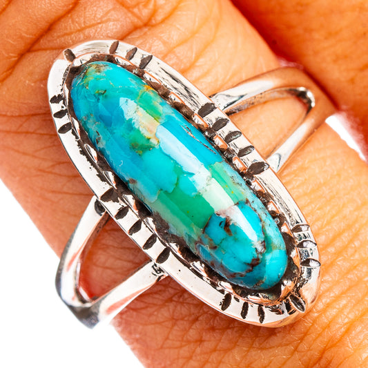 Sterling silver turquoise oval ring with patterned bezel and textured band