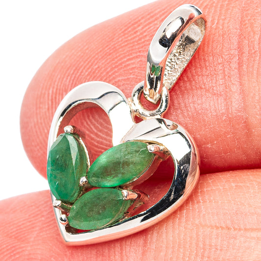 Heart pendant with three green emerald stones in polished sterling silver frame