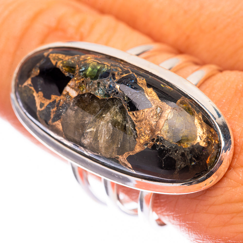 Oval sterling silver ring with dark gemstone and gold green flecks in bezel