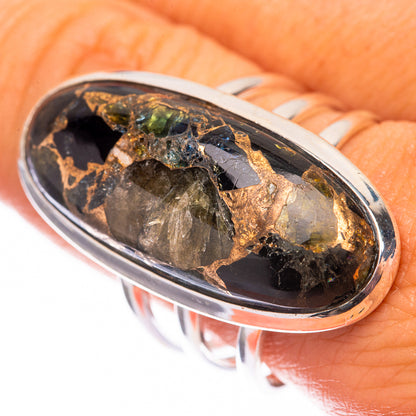 Oval sterling silver ring with dark gemstone and gold green flecks in bezel