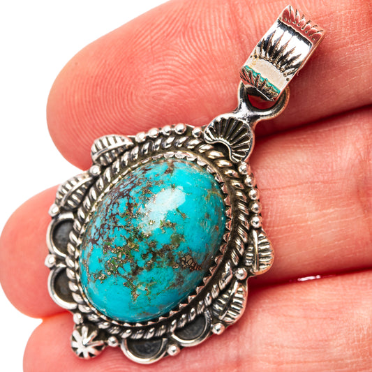 Sterling silver turquoise oval pendant with ornate bezel and textured edge detail