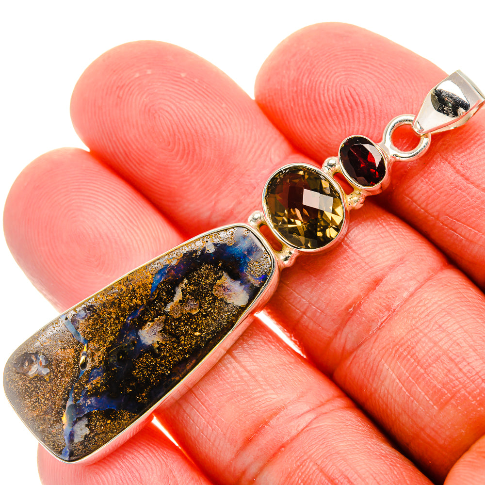 Sterling silver pendant with blue-gold boulder opal and yellow round gemstone accents