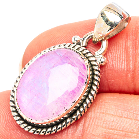 Pink moonstone pendant on finger, .925 sterling silver rope-edge oval bezel