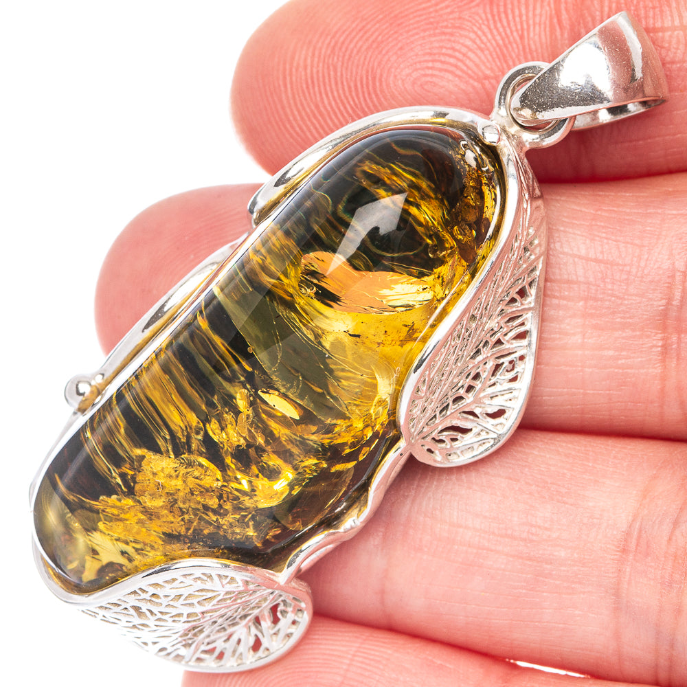 925 sterling silver pendant with oval Baltic amber cabochon and filigree sides