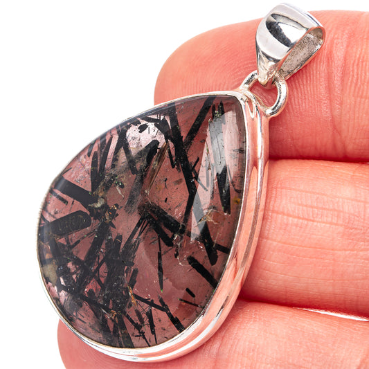Sterling silver setting teardrop tourmalated quartz pendant, close-up of dark needles