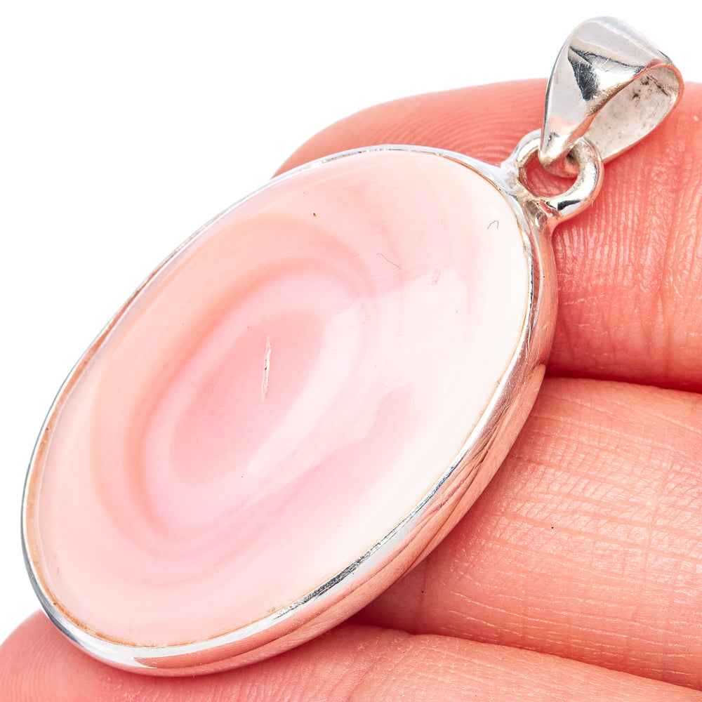Conch pendant close-up: oval pink shell swirl in sterling silver, with hanging bail