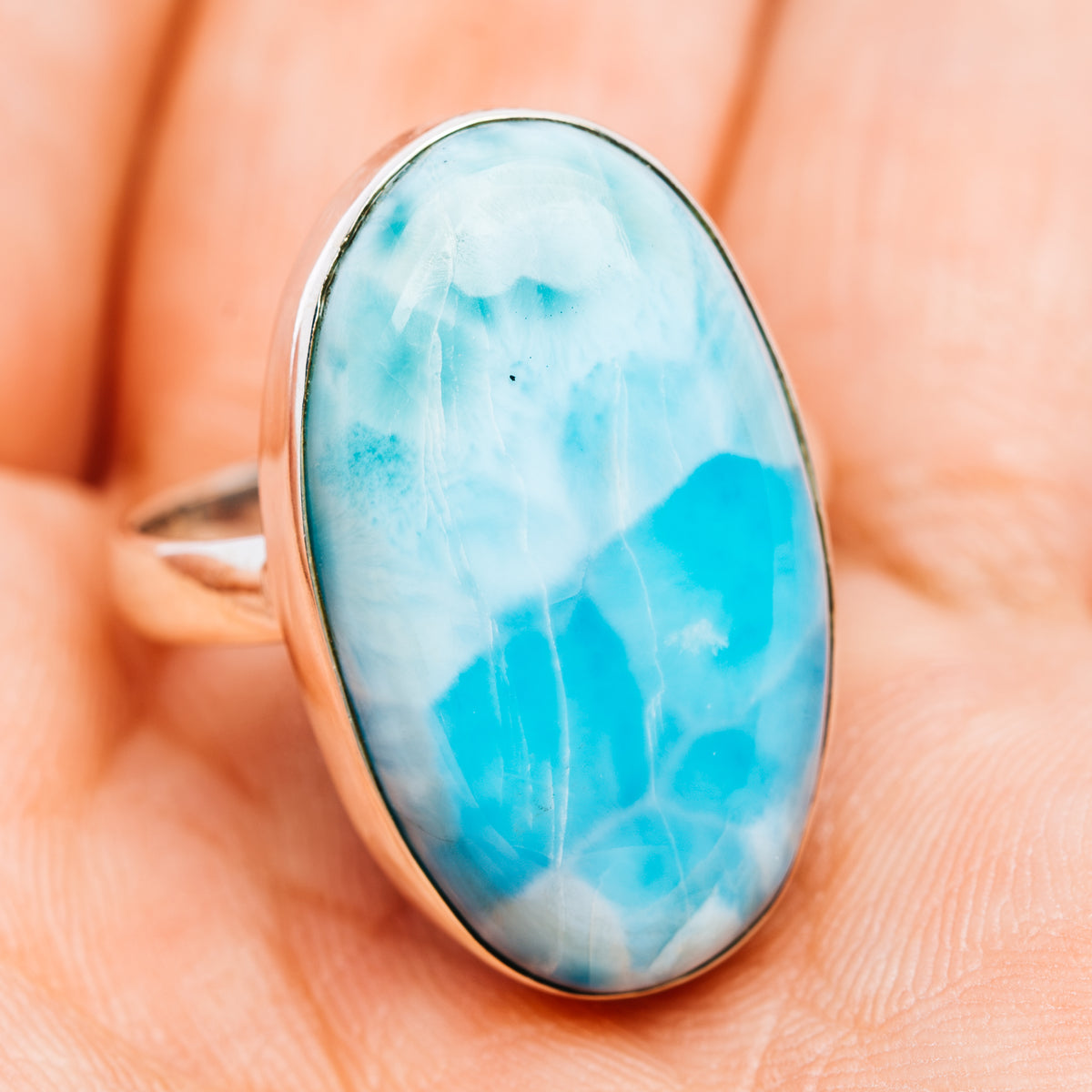 Oval sky-blue larimar cabochon ring with sterling silver bezel, front view