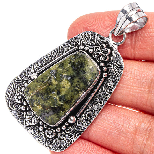 German silver unakite pendant with rectangular green stone and ornate floral border