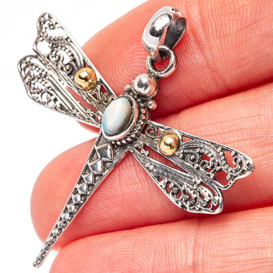Dragonfly pendant with oval light-blue gemstone, gold accents, and ornate sterling bail