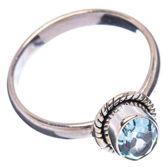 Sterling silver ring with oval blue topaz and braided border on the band