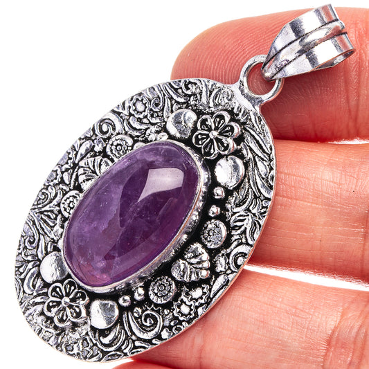 Amethyst pendant with oval purple cabochon in ornate German-silver frame