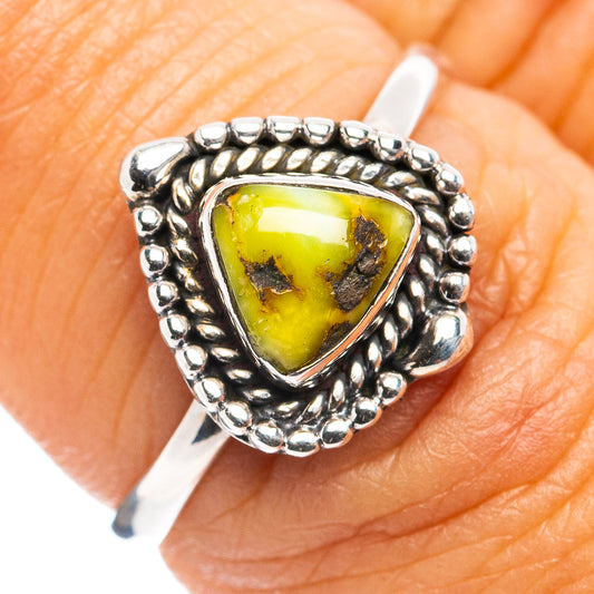 Sterling silver ring with oval bezel-set green-yellow stone and beaded frame