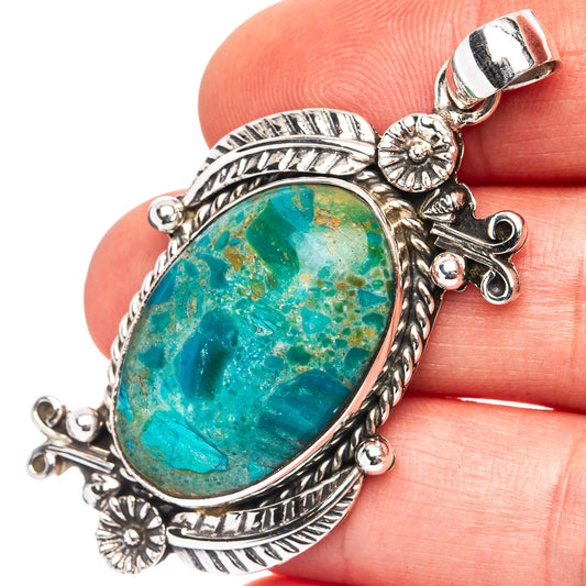 Oval turquoise opal pendant in .925 sterling silver, ornate leaf and flower frame