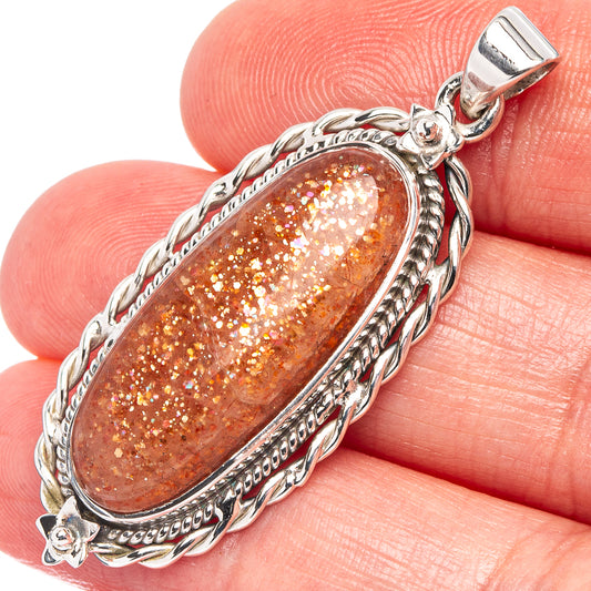 Oval sunstone pendant in .925 sterling silver, orange glitter cabochon with rope bezel