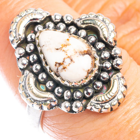 Sterling silver jasper ring with oval white stone and beadwork bezel, worn on finger