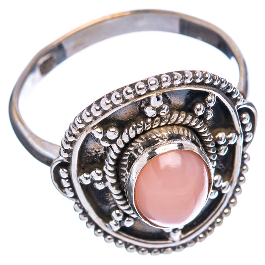 Sterling silver ring angled view with pink cabochon and engraved, beaded bezel