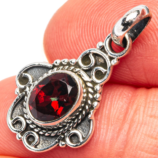 Garnet sterling silver pendant with round red faceted gemstone on filigree setting