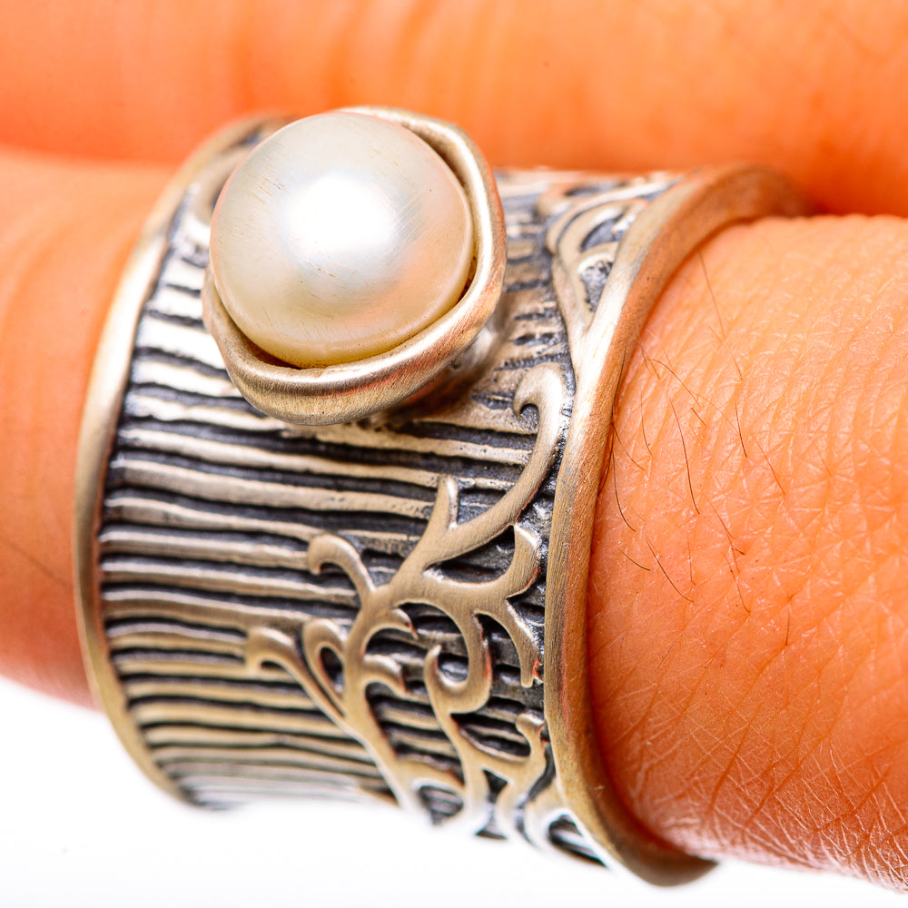 Cultured pearl ring with round white pearl and ornate filigree band, silver tone