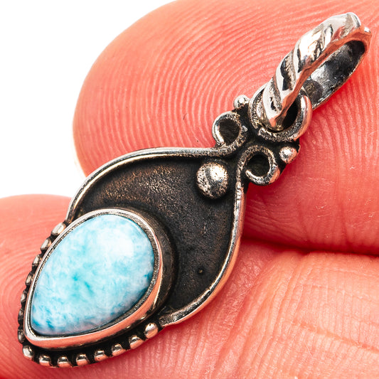 Sterling silver larimar pendant with oval blue stone and ornate bail, close-up