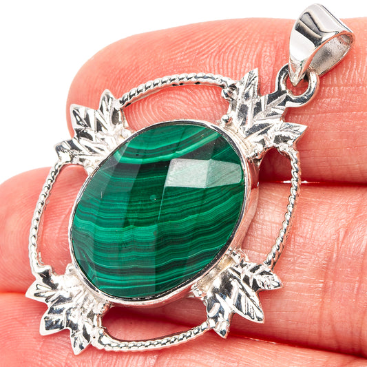 Oval malachite pendant in .925 sterling silver with ornate starburst frame and bail