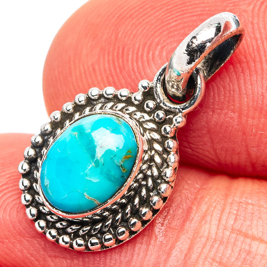 Turquoise and .925 sterling silver pendant with ornate oval bezel and loop bail