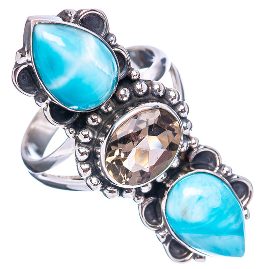 Sterling silver ring featuring two oval blue bezel stones and a round smoky faceted center