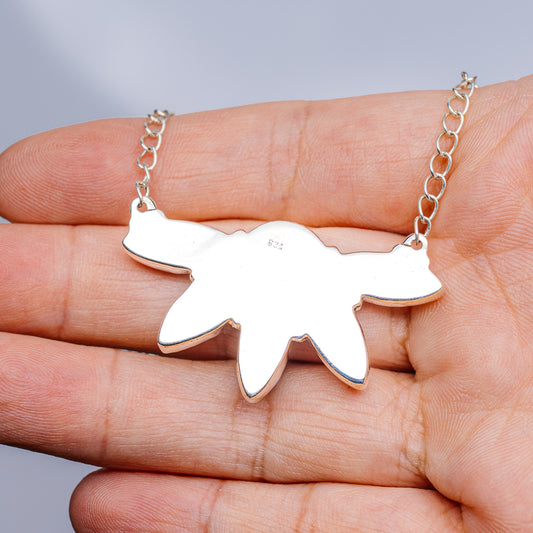 Silver chain necklace with starburst pendant and small round link pattern