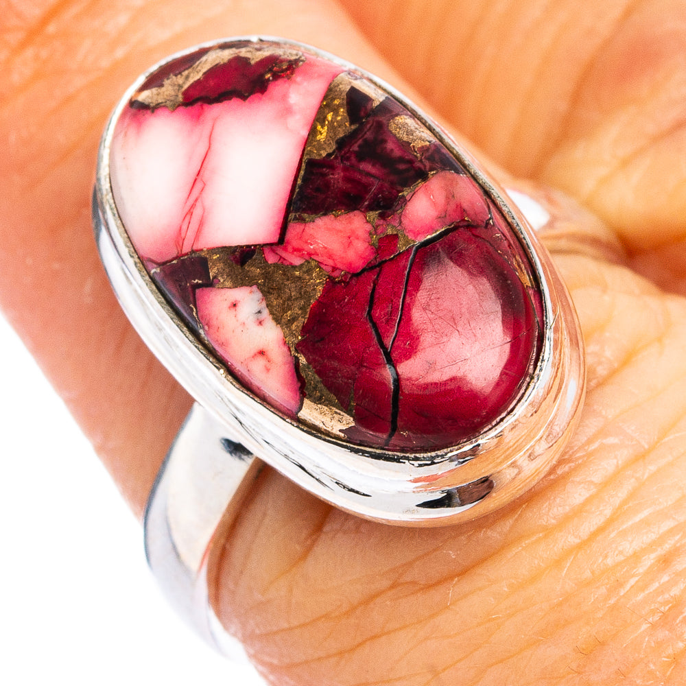 Sterling silver oval cabochon ring with pink-red and gold-toned stone in bezel