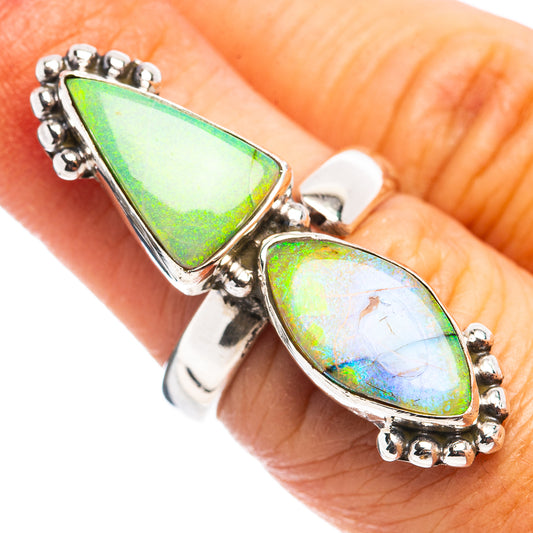 Sterling silver opal ring with green top and blue lower teardrop cabochons on hand