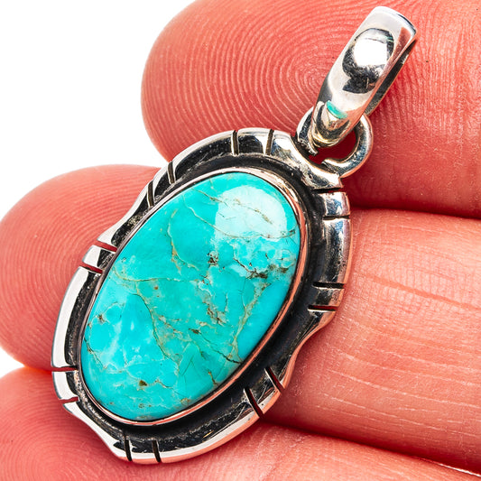 Oval turquoise stone pendant in .925 sterling silver bezel with rope-like border