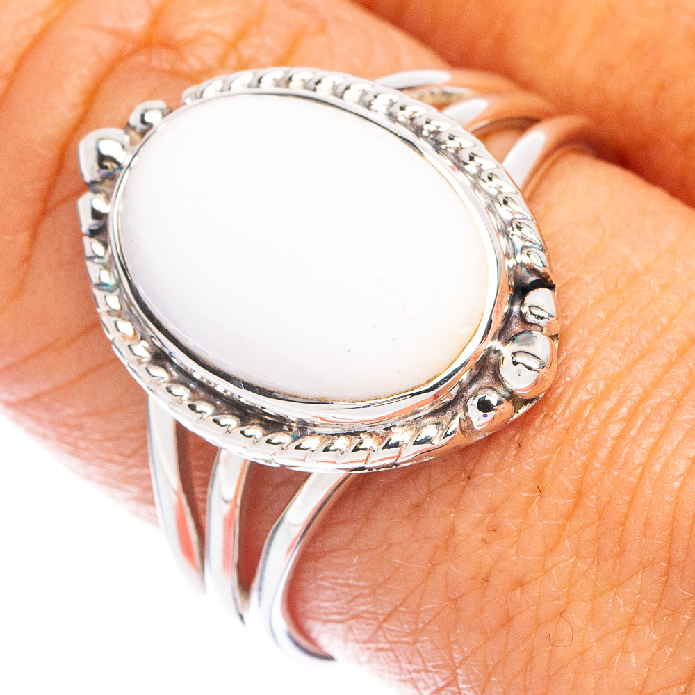 Sterling silver ring with oval white howlite cabochon and carved bezel detail