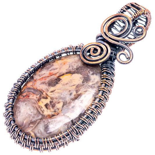 Oxidized copper wire-wrapped pendant with petrified palm root stone and coiled wire loops