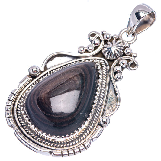 Sterling silver teardrop pendant with dark stone, starburst accents, and loop bail