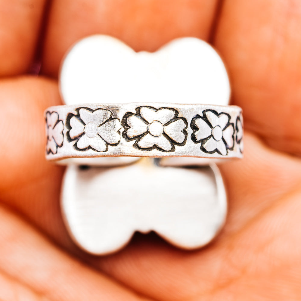 Sterling silver ring band with engraved flower pattern and scalloped edge