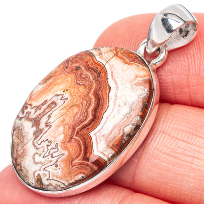 Crazy lace agate pendant in oval sterling silver bezel with bail, red and cream lacy bands
