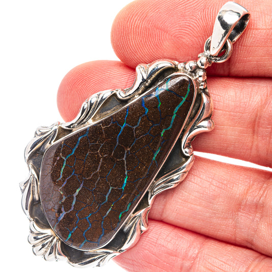 Sterling silver boulder opal pendant with oval dark stone and blue-green veining