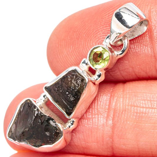 Peridot and moldavite pendant, .925 sterling silver with round green stone and dark crystal.