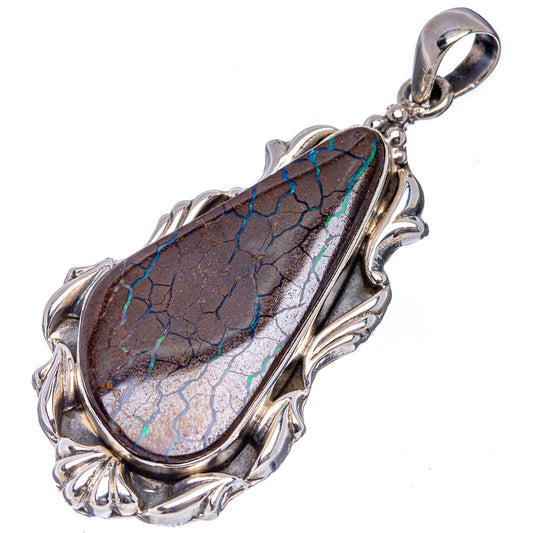 Sterling silver boulder opal pendant with elongated oval dark opal and ornate leaf bezel