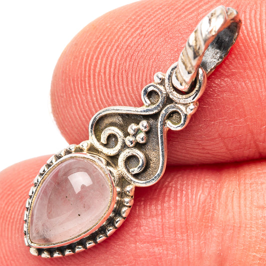 Oval rose quartz pendant with ornate .925 sterling silver filigree setting and loop bail