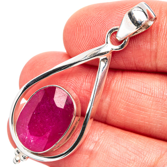 Sterling silver ruby pendant with oval purple gemstone in teardrop setting, close-up