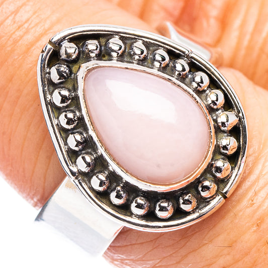 Sterling silver ring with pink teardrop opal and round bead bezel detail