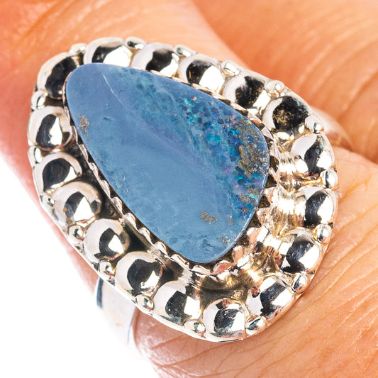 Blue oval opal ring in .925 sterling silver with ornate bezel prong setting