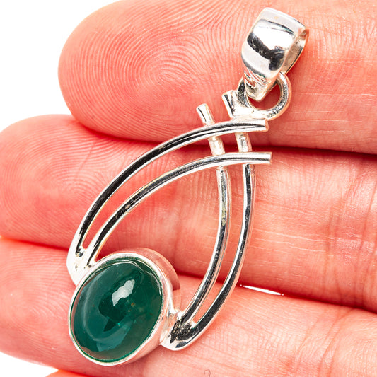 Sterling silver oval green gemstone pendant close-up with curved arc frame