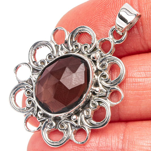 Sterling silver smoky quartz pendant with ornate filigree frame and dark oval stone