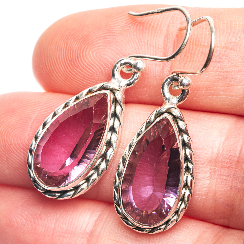 Sterling silver teardrop earrings with purple faceted gemstones in ornate frames