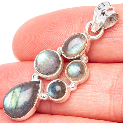 Labradorite pendant close-up: five iridescent oval stones in silver with bail