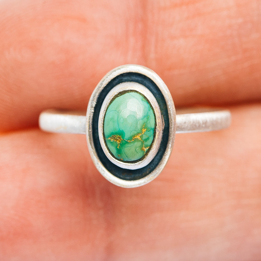 Sterling silver turquoise oval ring on band, double bezel with dark edge detail